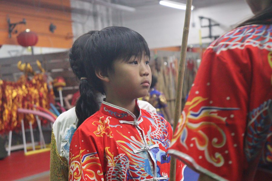 A student in embroidered competition silks