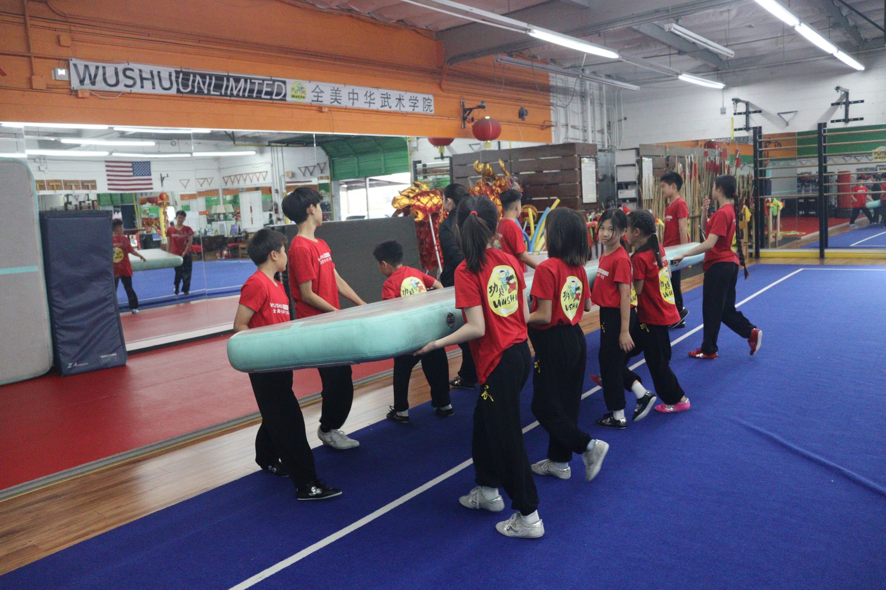 Young students working through a coordination drill with their coach