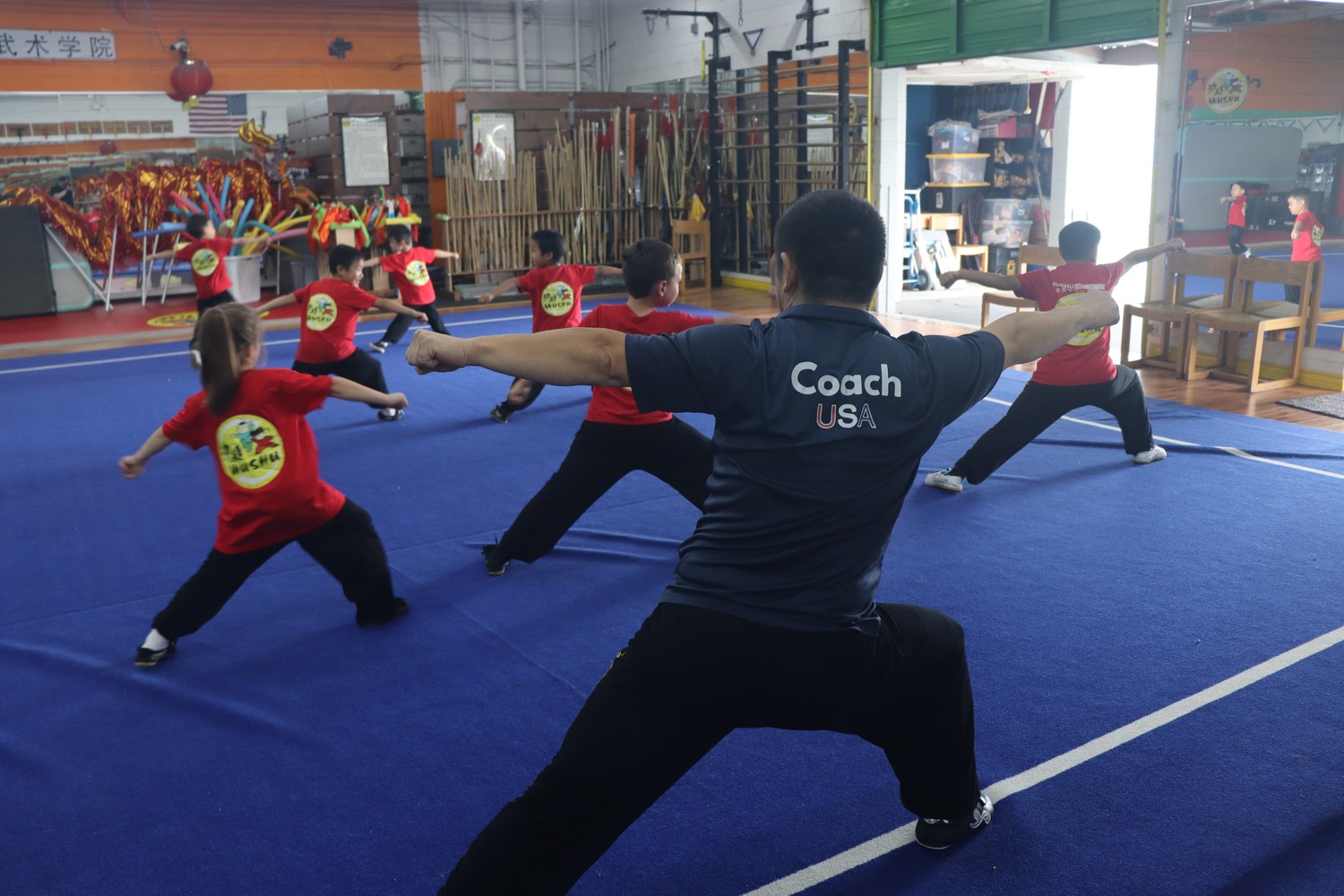 Coach leading a class from a deep bow stance